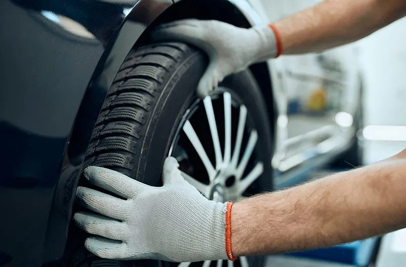 Mechanic checking Wheel Alignment and ADAS Calibration
